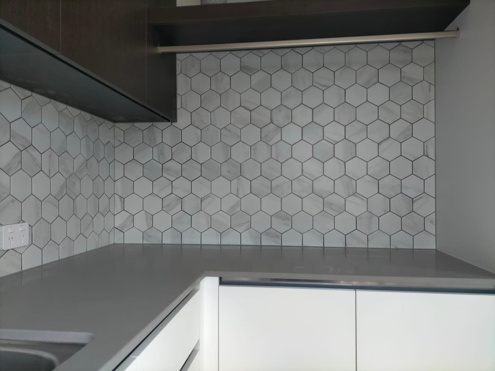 Laundry splashback — hexagon tile installation
